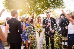 bride and groom recess down aisle with environmentally friendly confetti