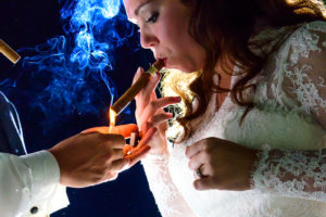 Bride and groom smoking a cigar at the madison club