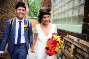 bride and groom walking out of bang salon in madison