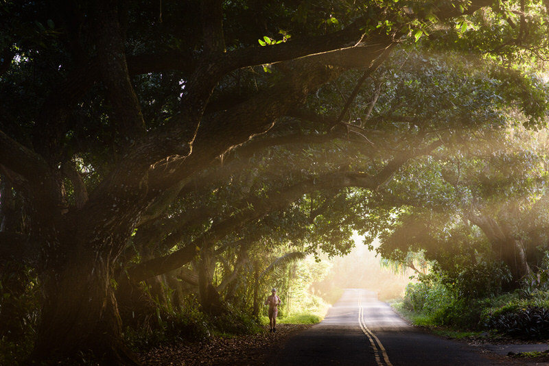 man jogging on sun soaked road on the big island of Hawaii