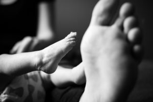mother and newborn son feet black and white