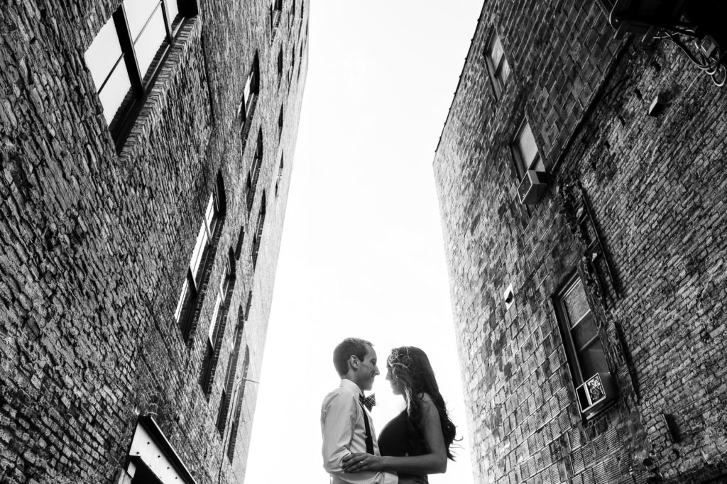 Milwaukee third ward engagement session between two brick buildings