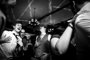 groom and groomsmen dancing and singing to spice girls