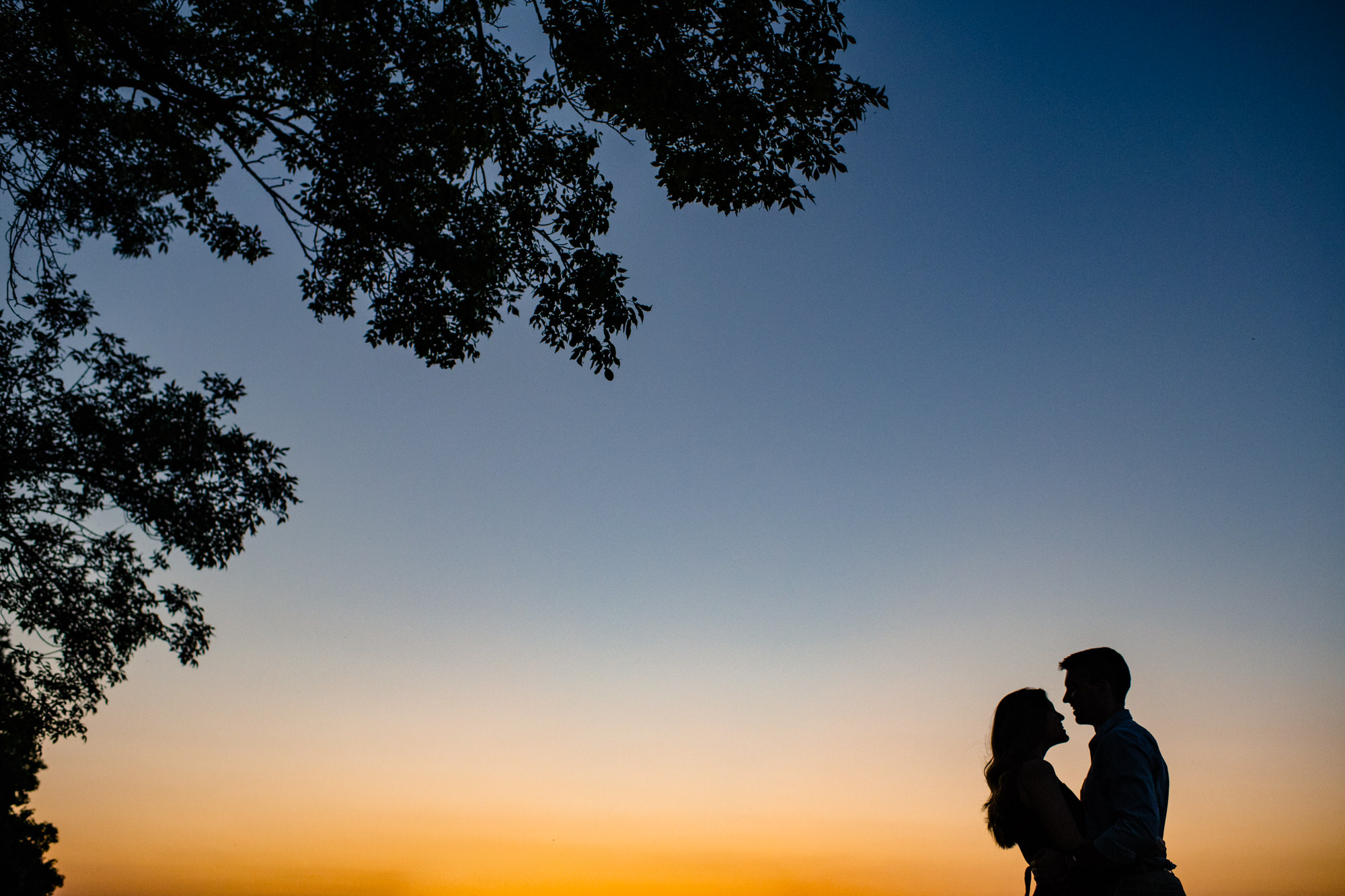 memorial union terrace at sunset with couple during engagement session in madison Wisconsin