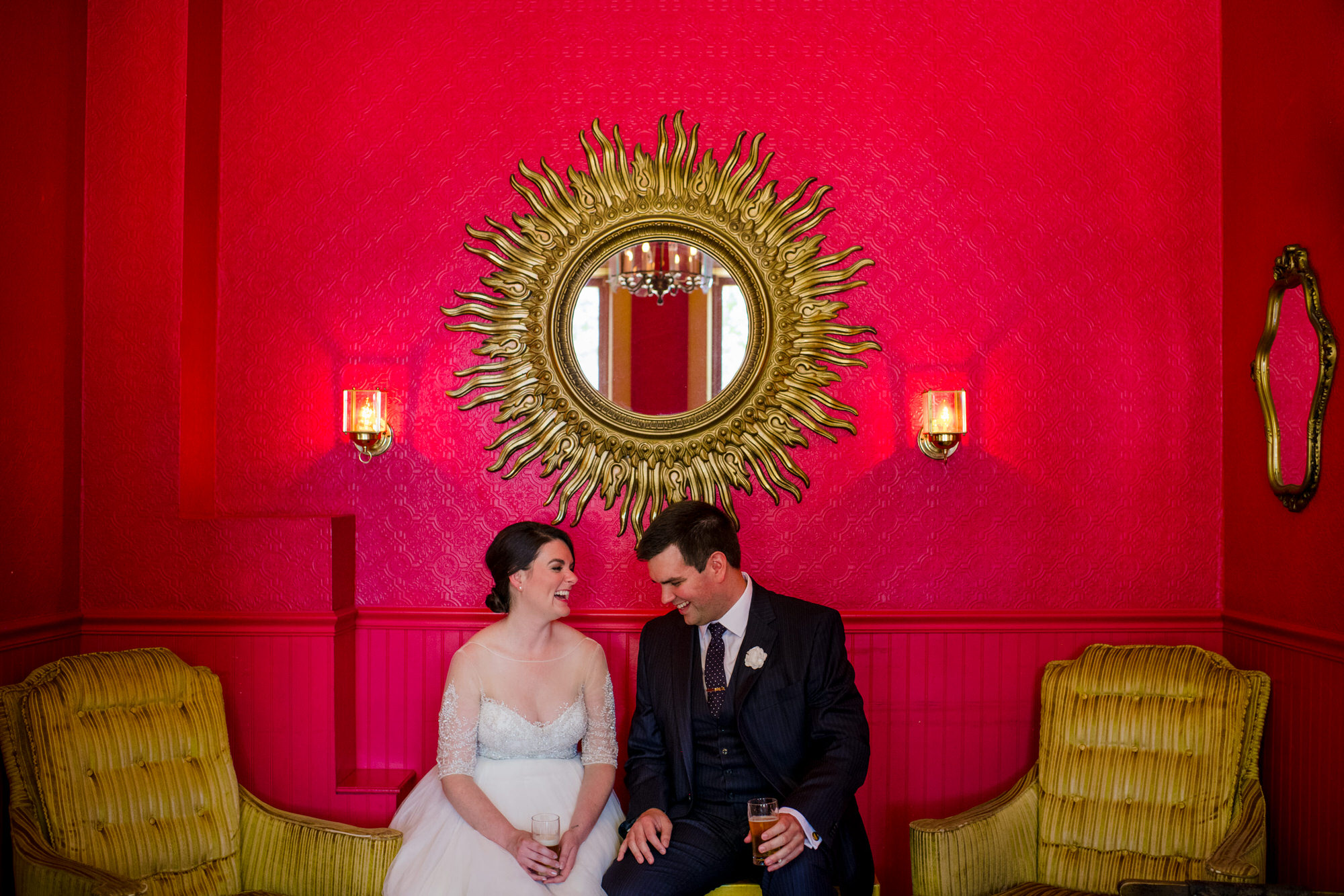 bride and groom enjoying beers in mickeys red room