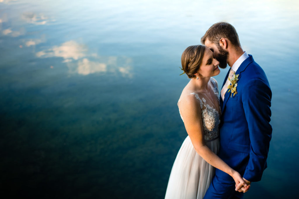 bride and groom snuggle at camp manitou