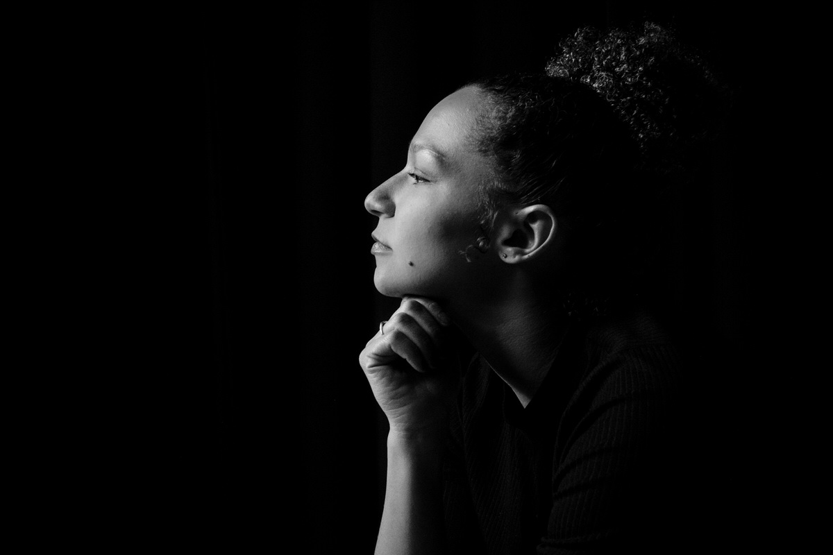 Woman sits for a portrait in black and white