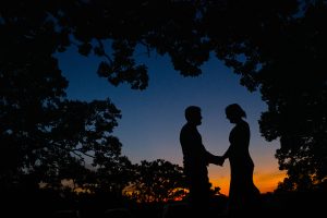 Couple holds hands at sunset at Hoyt park