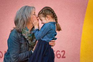 grandma hugs and kisses granddaughter in Appleton Wisconsin