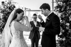 bride and groom cry while they exchange vows