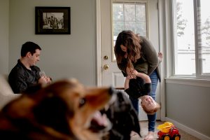 mom holds son upside down