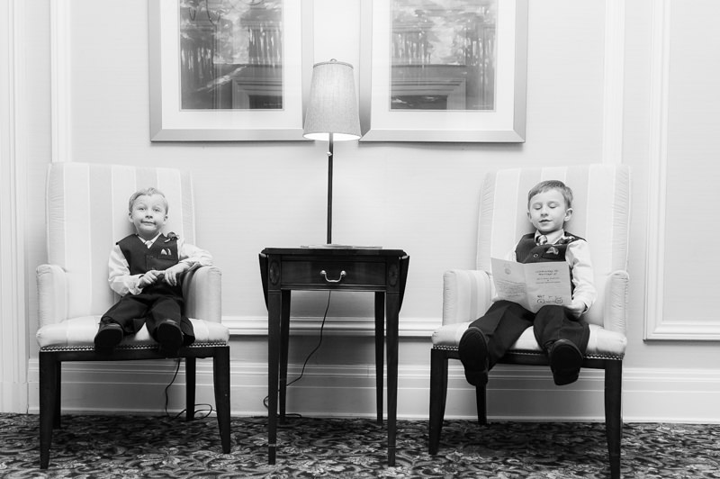 Two boys in tuxedos sitting at the Madison 