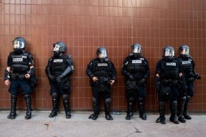 Police in riot gear line up outside of the state historical museum in Madison, Wisconsin during George Floyd protests.